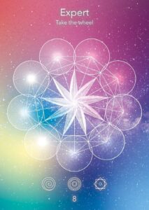 Expert tarot card featuring intricate geometric patterns and a central star design against a colorful cosmic background.