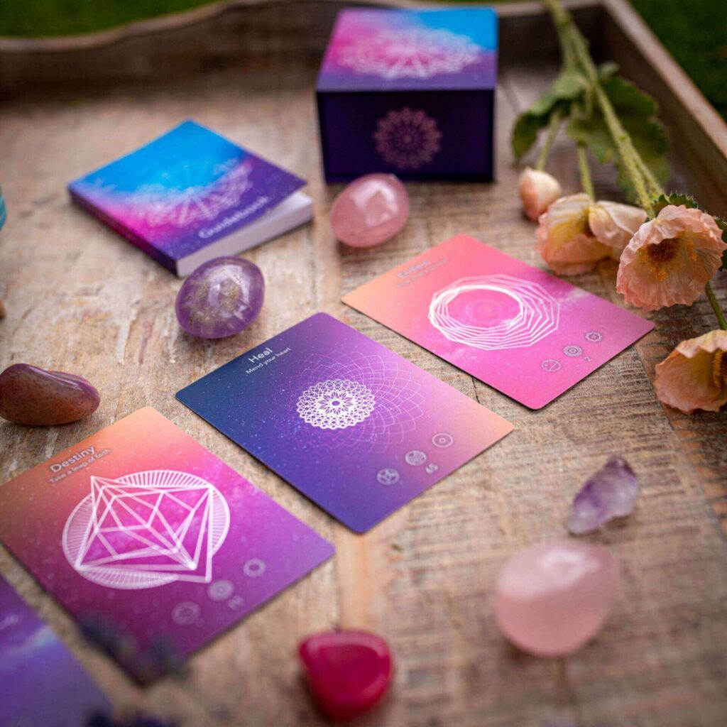 A vibrant set of meditation cards featuring geometric designs and crystals