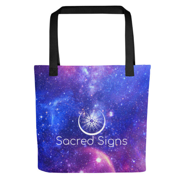 Black tote bag with purple-blue galaxy print and Sacred Geometry peace symbol, text “Sacred Signs,” and starry cosmic detail in motion.