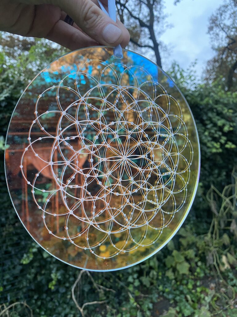 Intricate geometric glass art featuring a circular design with interconnected patterns, showcasing craftsmanship and artistic detail.