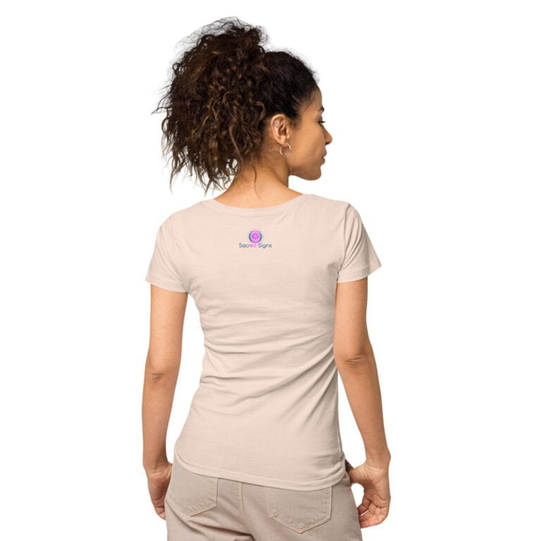 A woman wearing a light beige t-shirt featuring a logo on the back, showcasing a casual and comfortable style suitable for everyday wear.