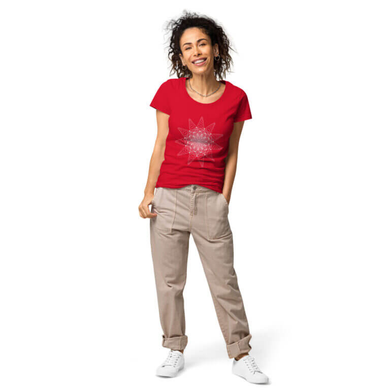 Red t-shirt featuring a star graphic design, paired with beige pants and white sneakers, modeled by a smiling woman.